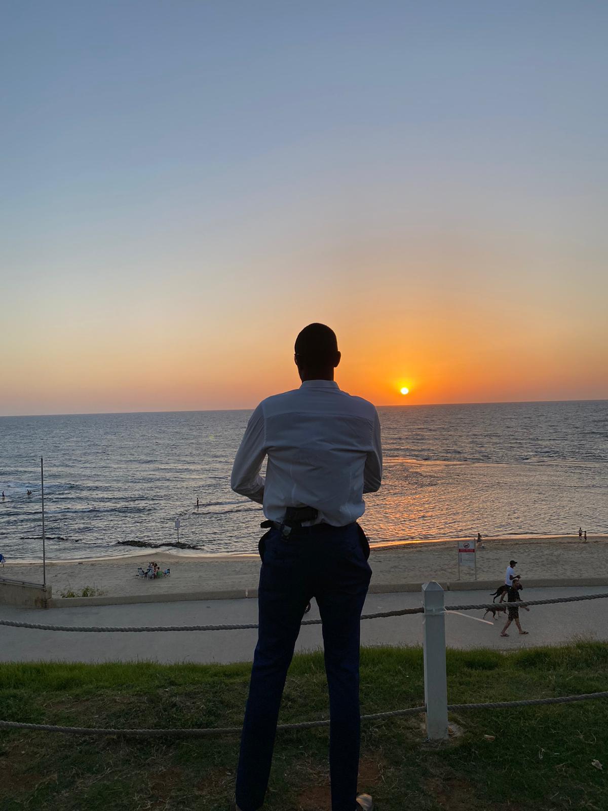 Adael Bryant — silhouette at sunset, watching the sea
